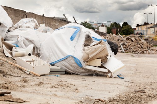 People disposing of furniture in Crouchend recycling center